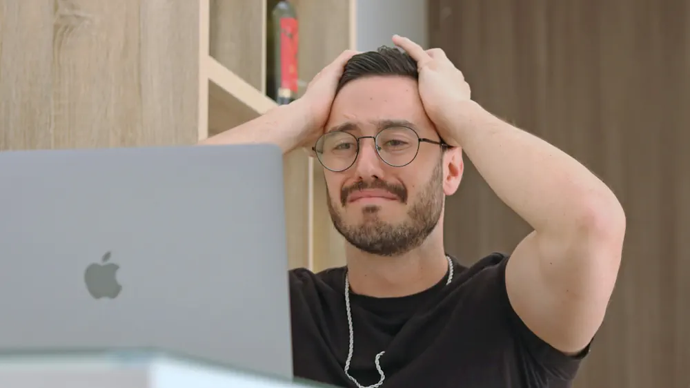 Image shows a man frustrated his laptop because his peaches are not showing Google It has probability issues