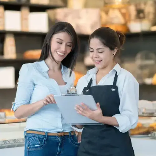 Two business owners check on the success of their Brownsville Local SEO. 